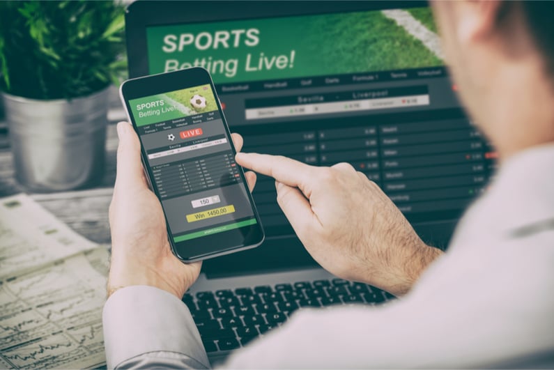 Betting on phone with laptop