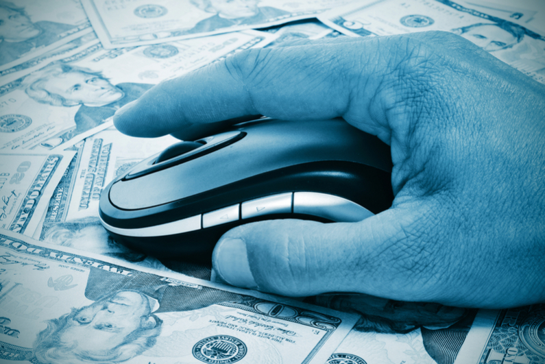 Hand with mouse against background of US currency