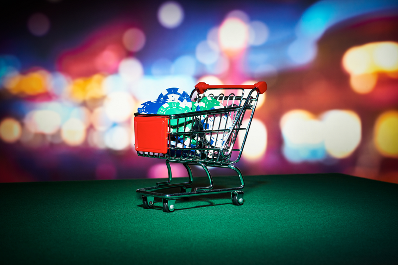 Cart filled with poker chips on casino table.