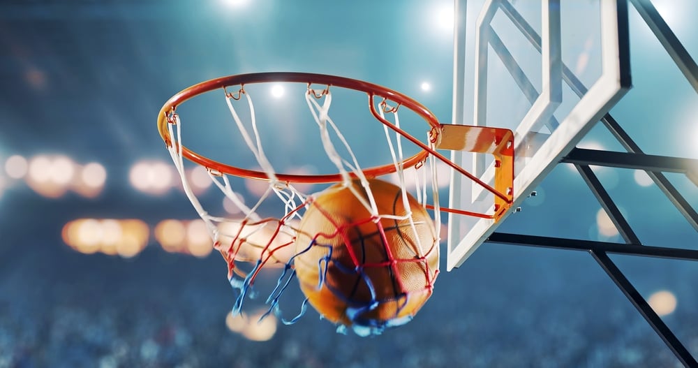 basketball going through hoop in basketball court