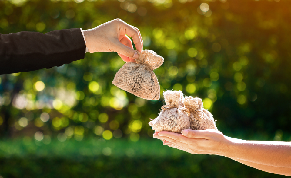 male handing satchels of money to female