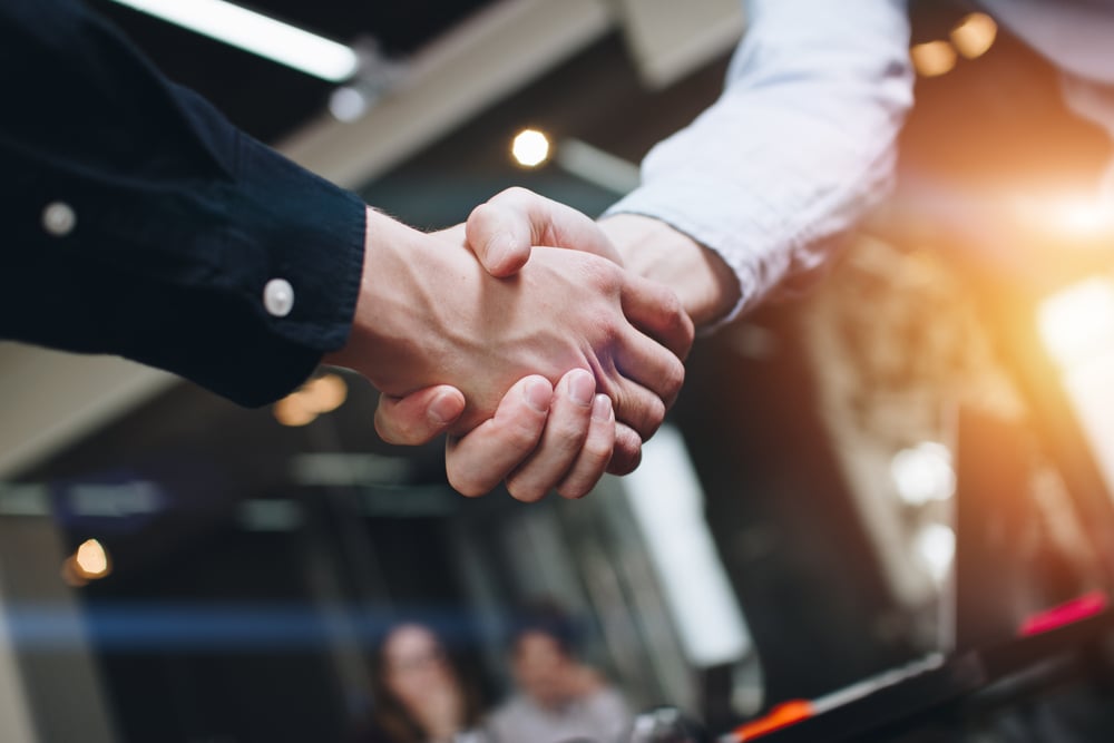 two business people shaking hands symbolizing agreement