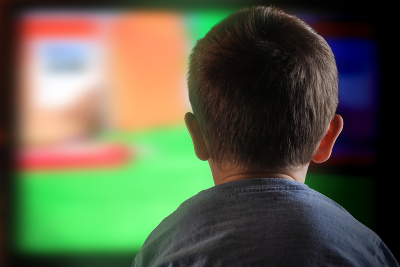 Little boy watching television